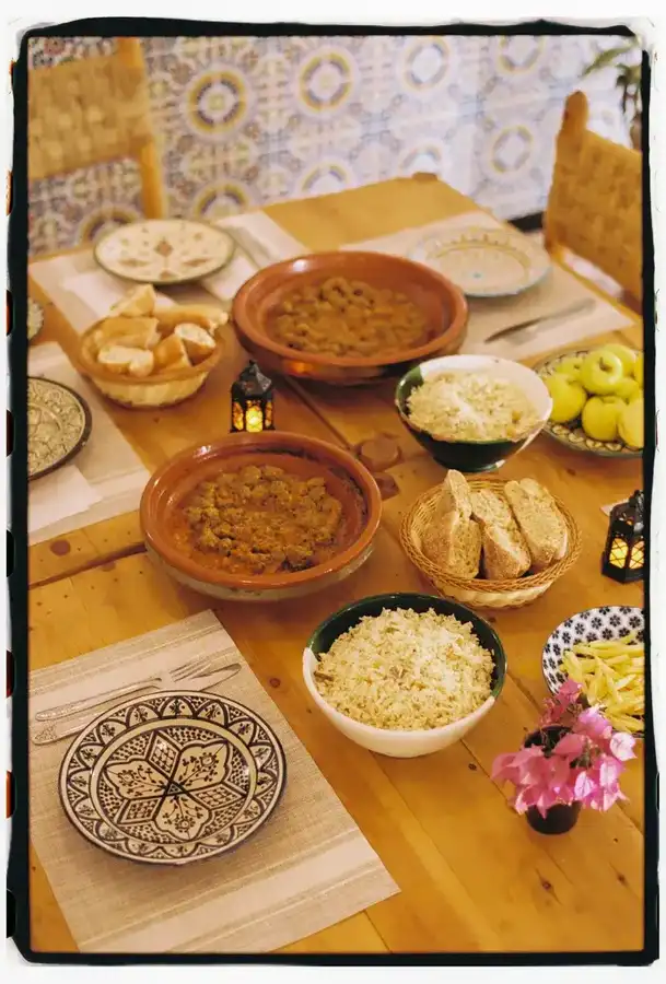 Tagine dishes and decorated plates on a wooden table