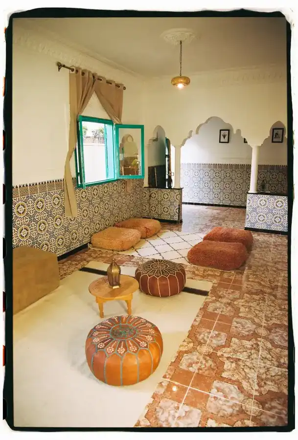 Salon with poufs, Berber rug and zellige columns
