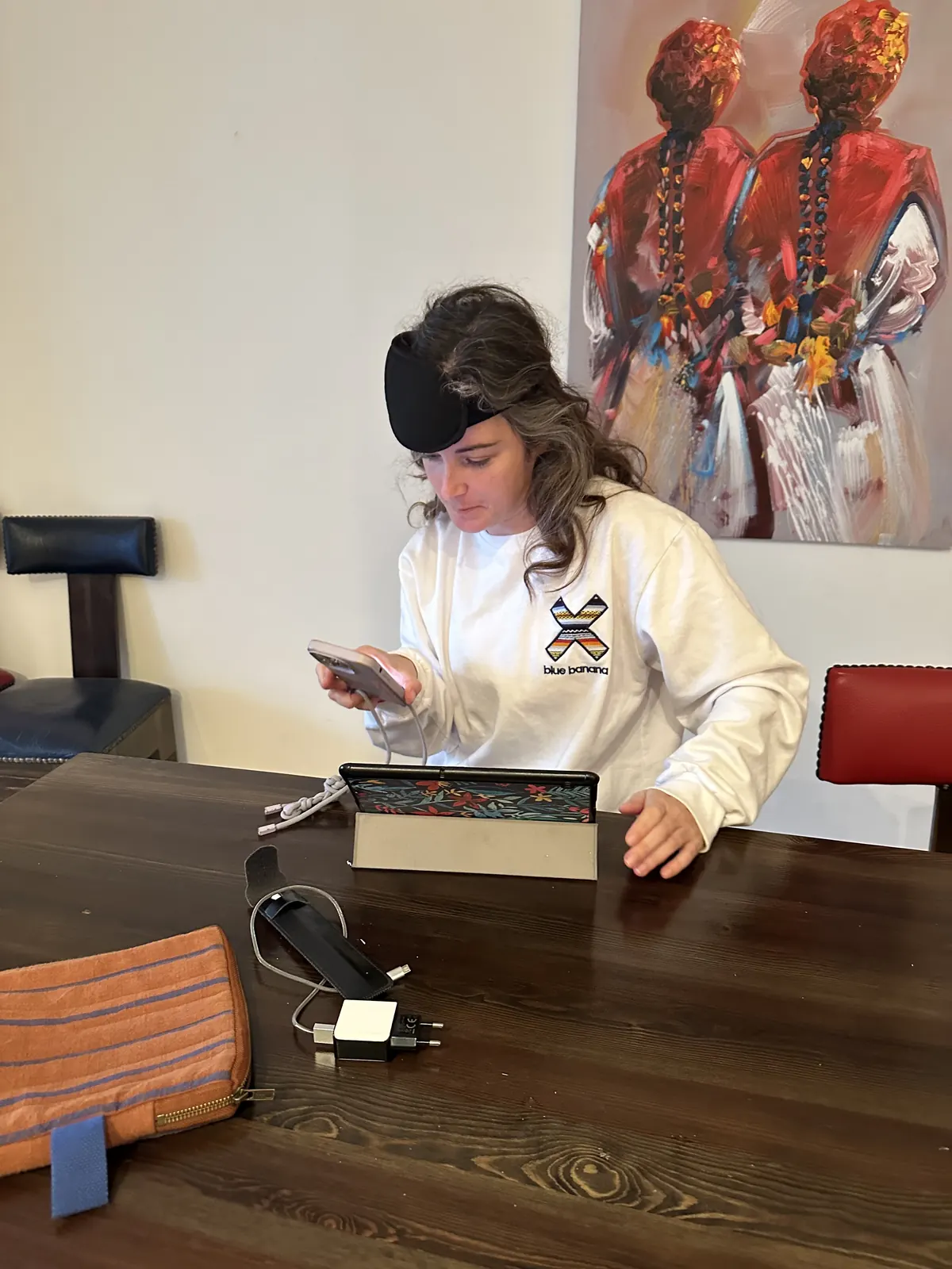 Guest checking her phone next to her laptop at the camp