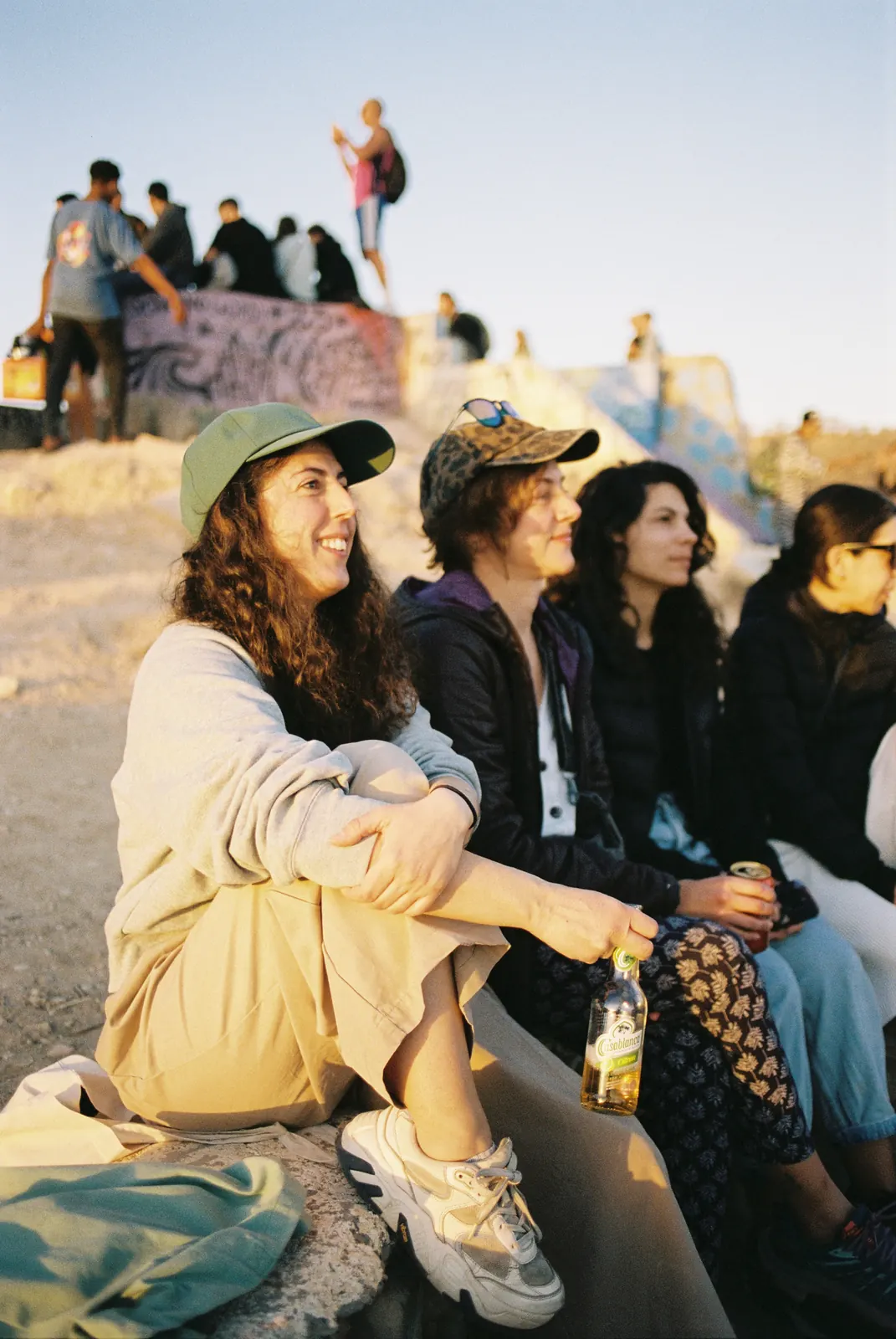 Friends sitting in the evening sun at the Taghazout skatepark