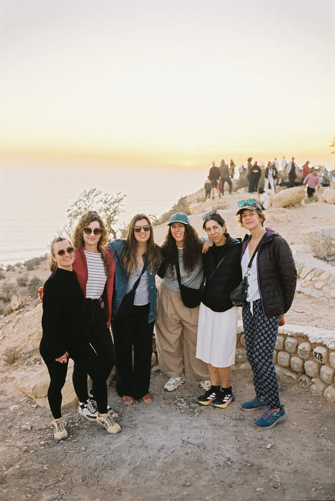 Camp friends together at the sunset viewpoint above the ocean