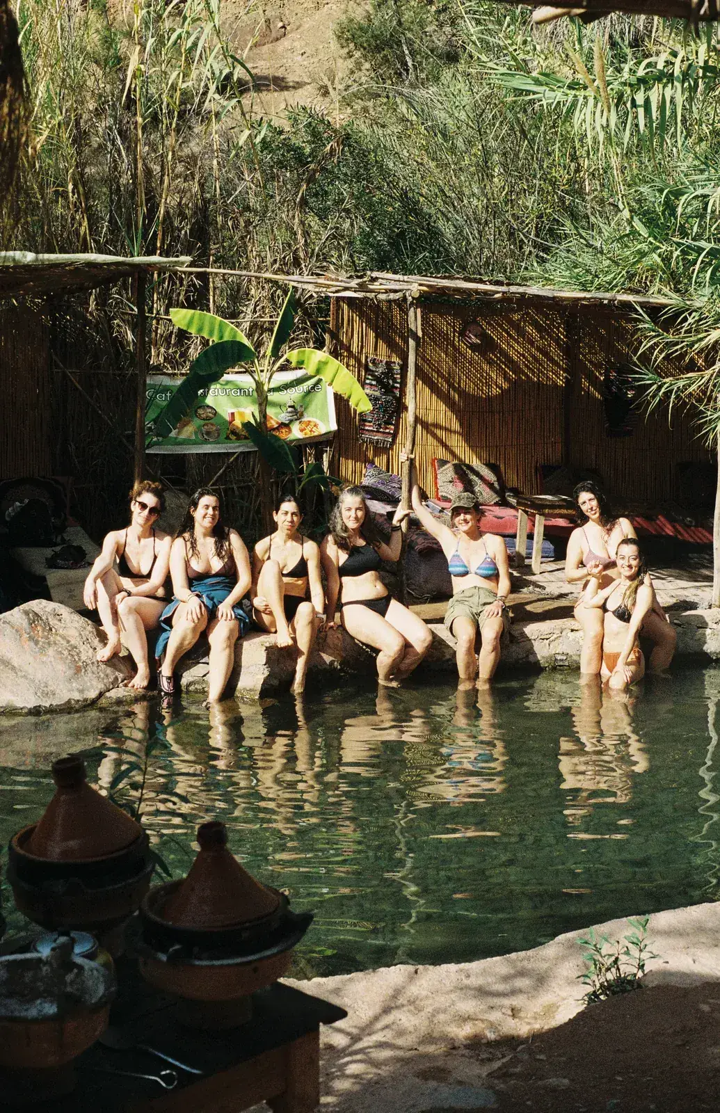 Guests sitting by the natural pools of Paradise Valley