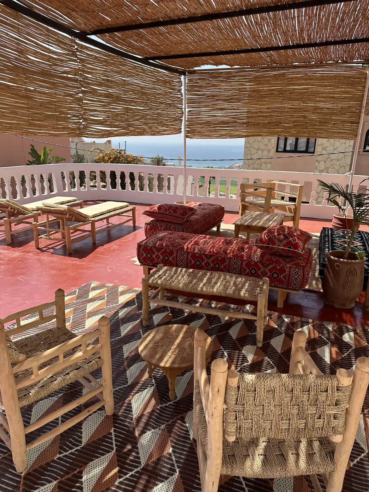 Shaded rooftop lounge at the camp with reed canopy and Atlantic views