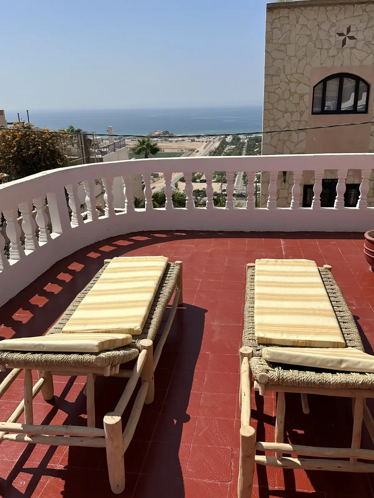 Rooftop terrace with loungers and sea views