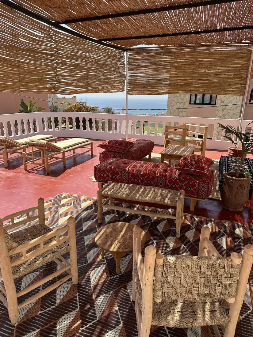 Shaded rooftop lounge with sea views