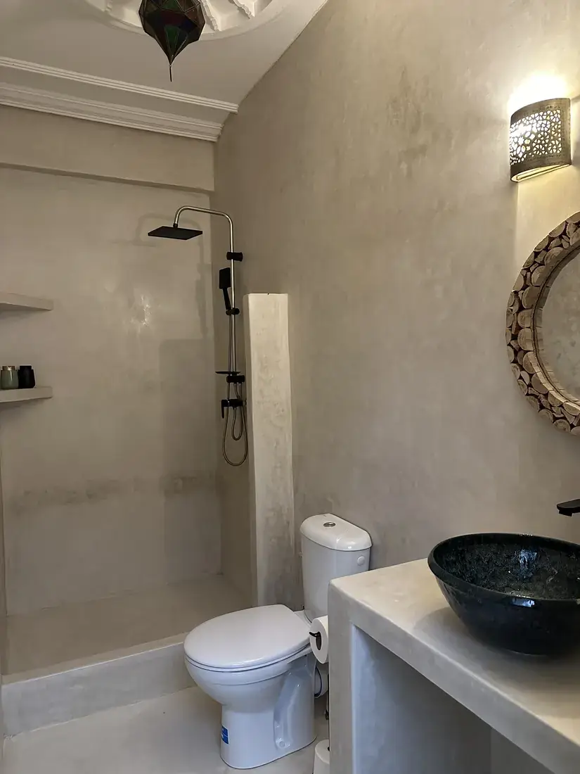Bathroom with handcrafted mirror and vessel sink