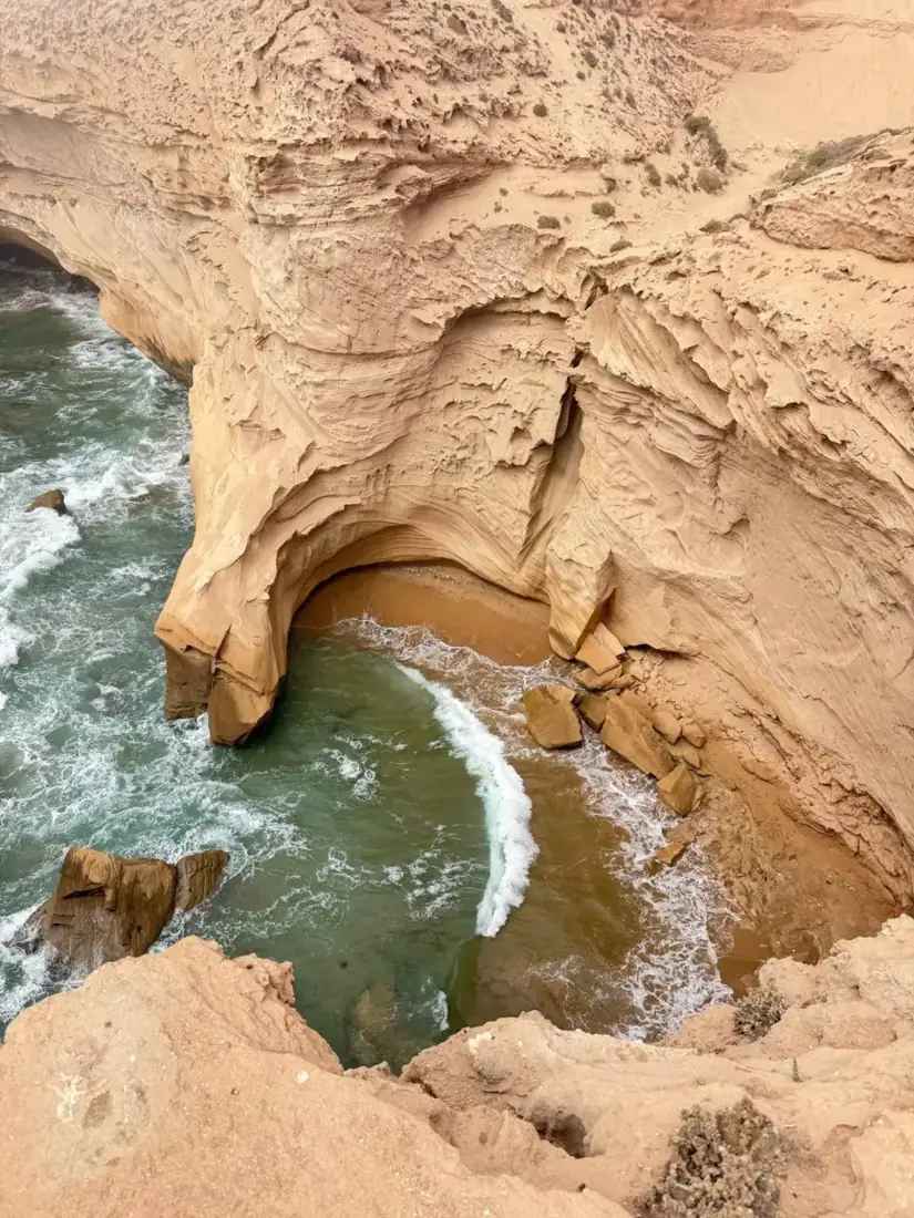 Golden cliffs and a sea cave on the Atlantic