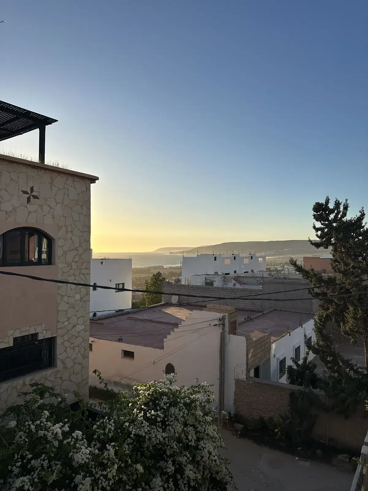 Tamraght rooftops and the coast at dusk