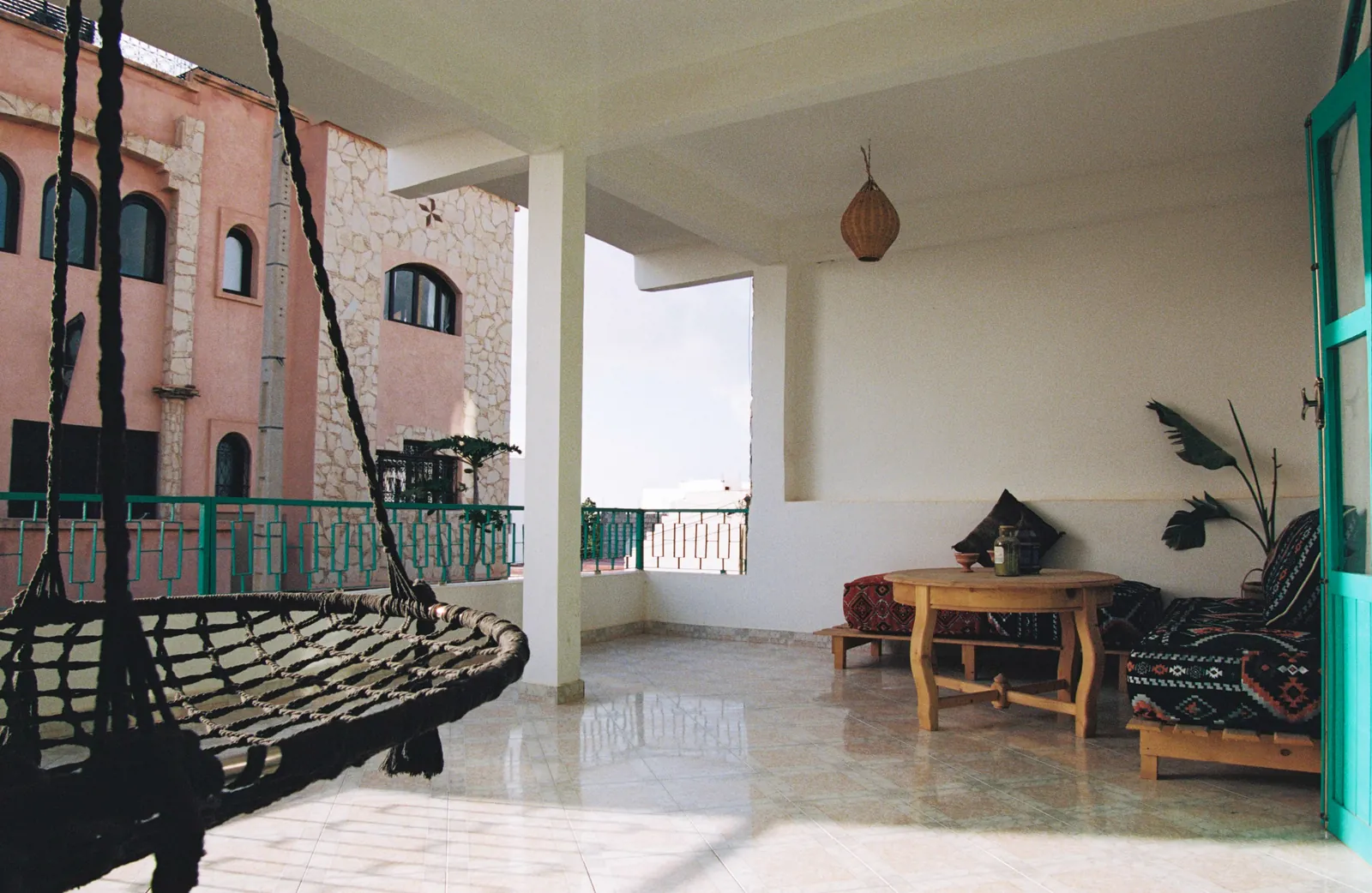 Covered terrace with a hanging nest swing