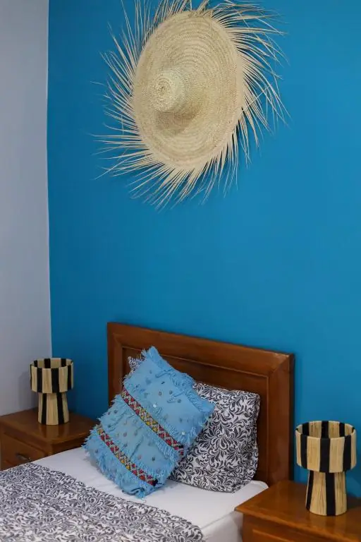 Single bed with a straw hat