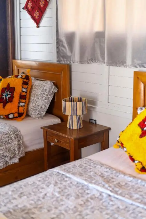 Bedside detail with yellow cushions