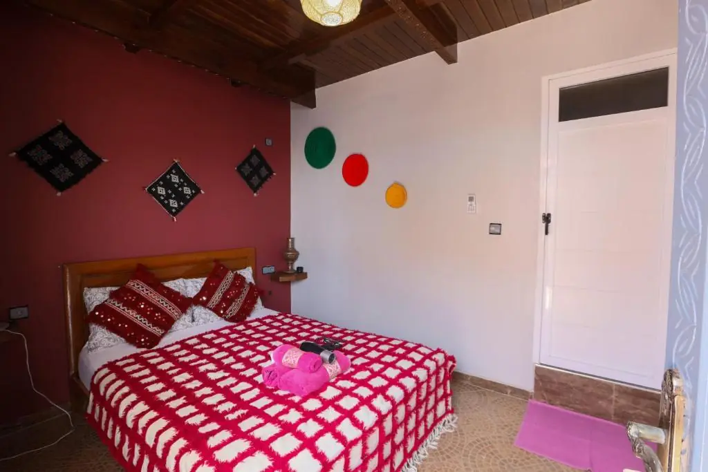 Double bed with red cushions