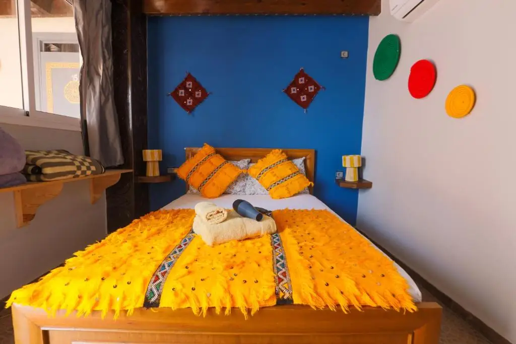 Double bed with a yellow Berber blanket