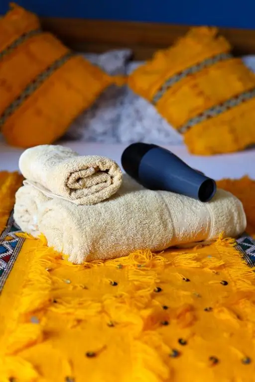 Fresh towels on a yellow blanket