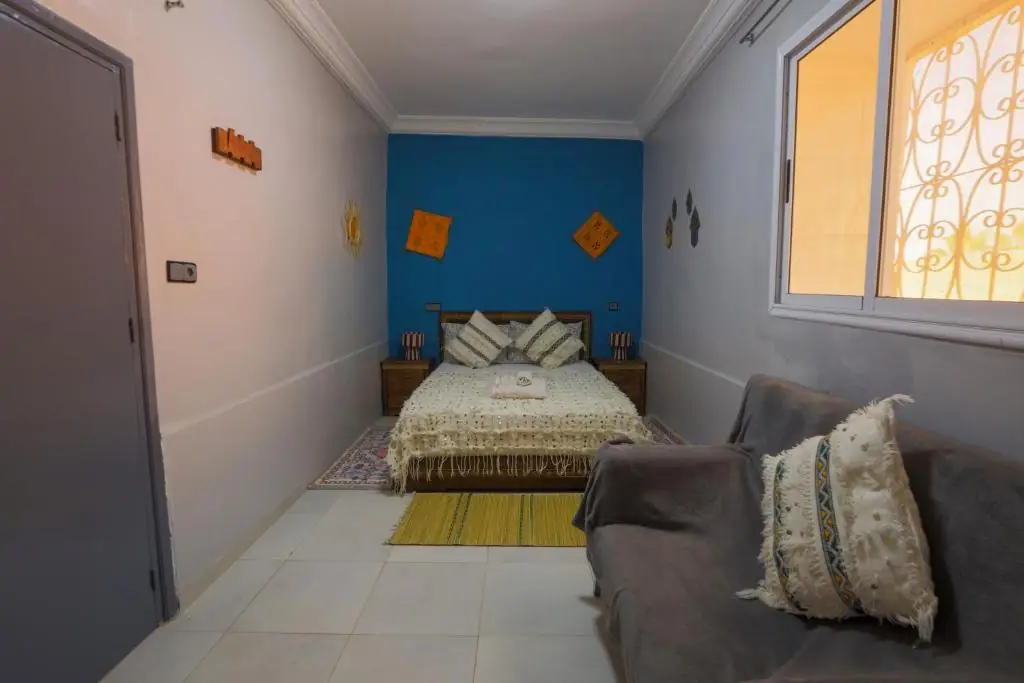 Double room with a handira blanket and sofa