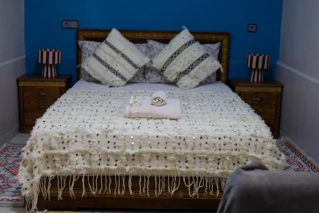 Double bed with a white handira blanket