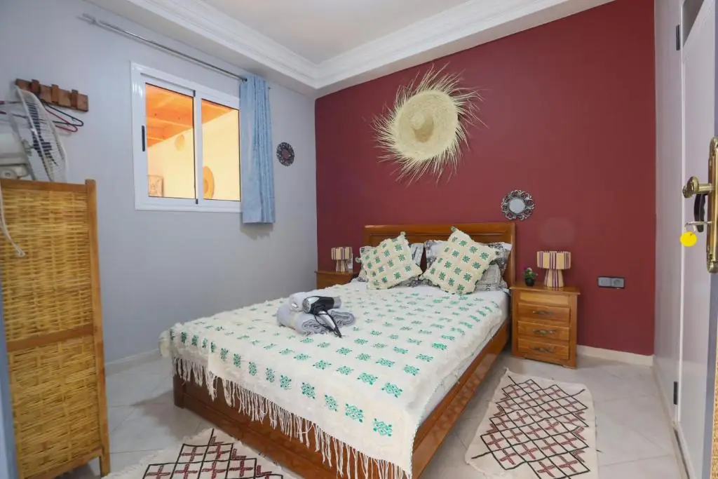 Maroon double room with Berber cushions