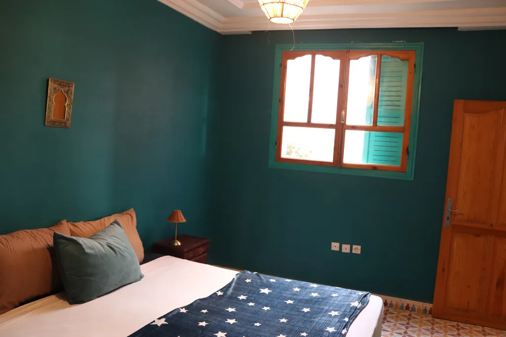 Teal room with a wooden window