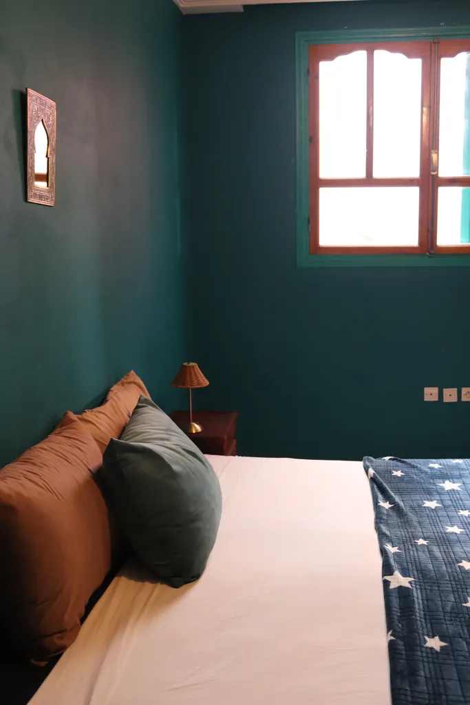 Bed with teal and copper cushions