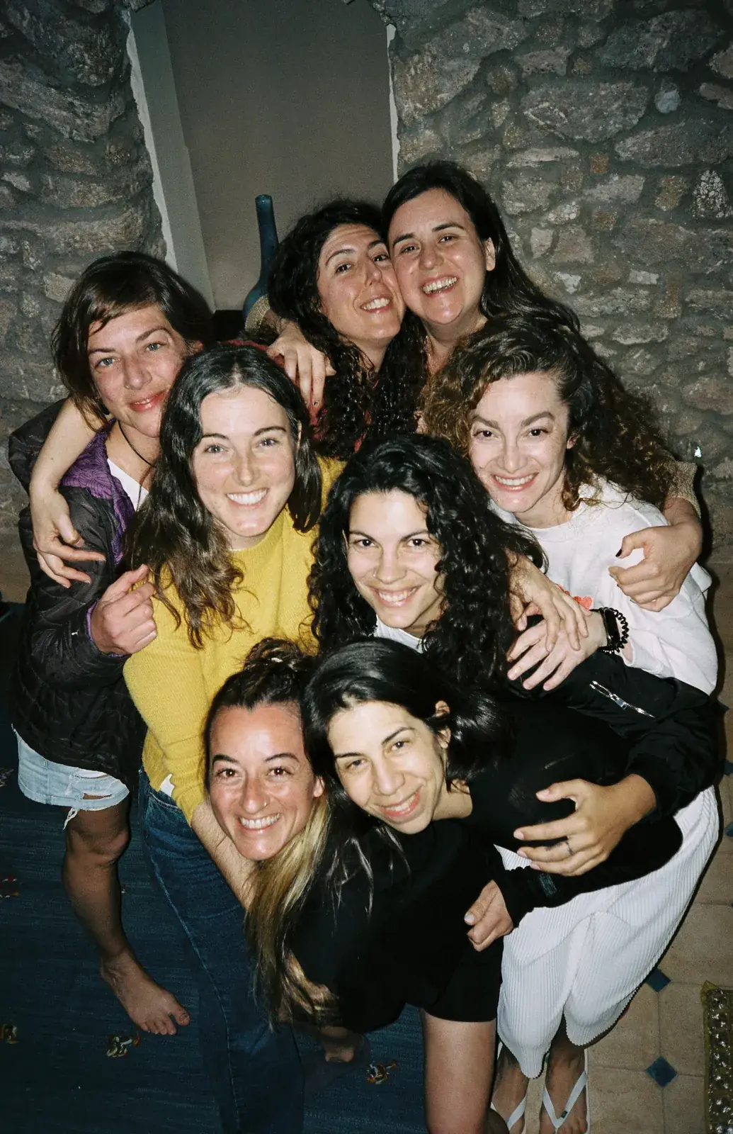 Group of friends hugging and laughing at the riad