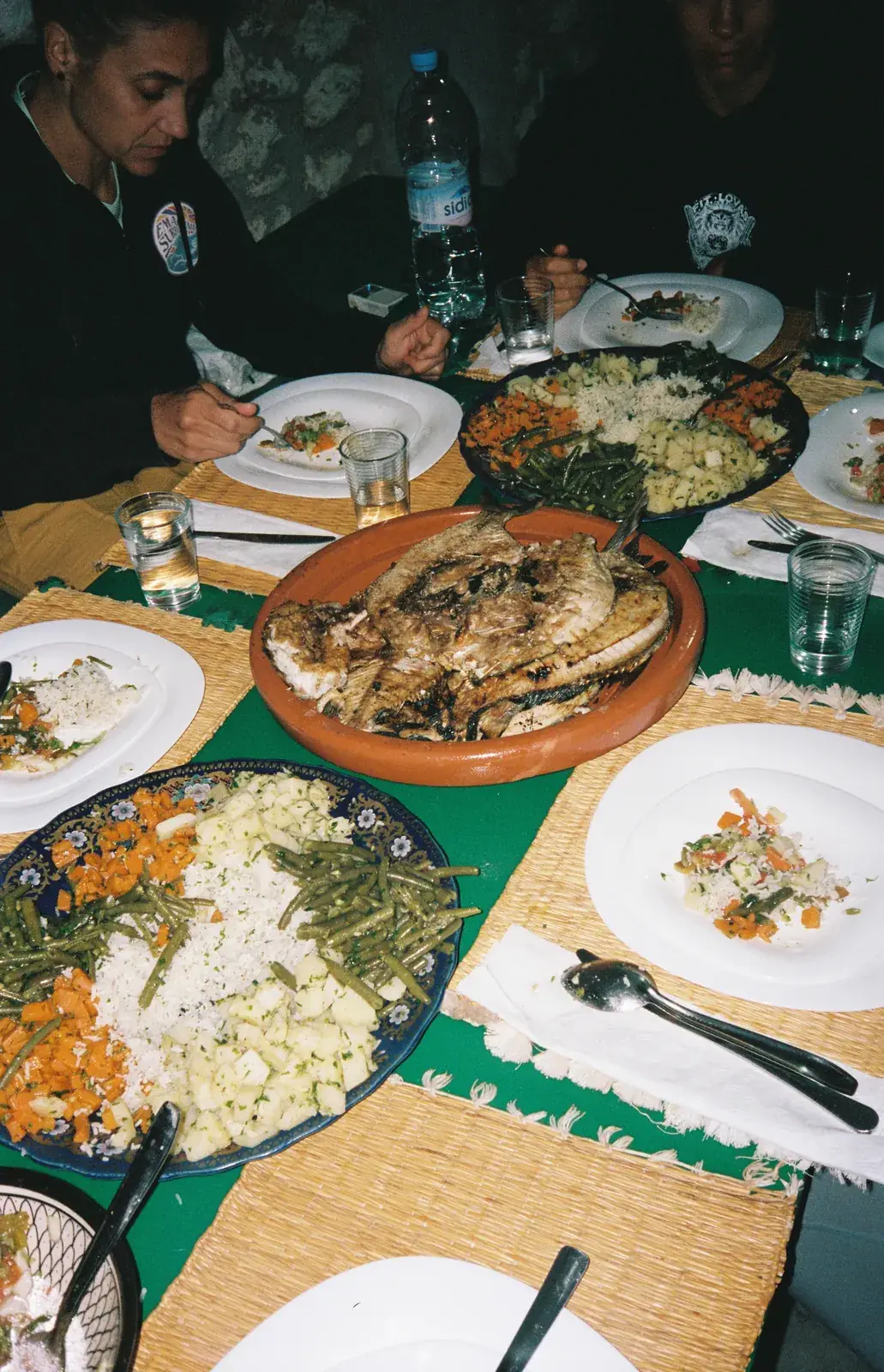 Grilled fish, rice and vegetables shared at dinner