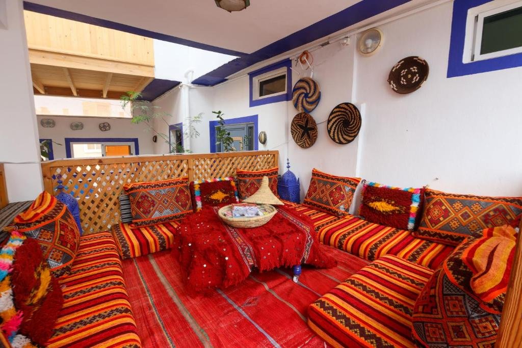 Rooftop workspace at a surf riad in Tamraght with a laptop and ocean view